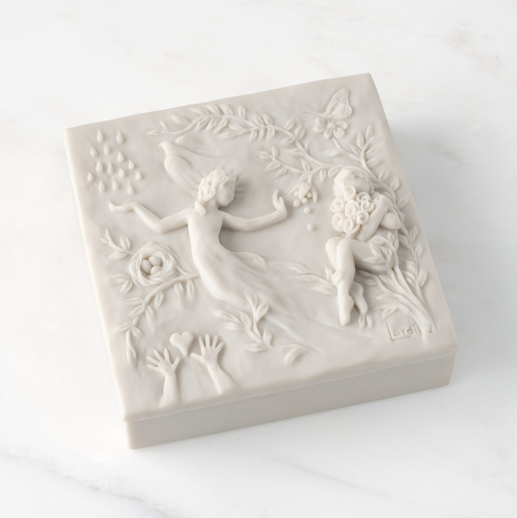 Closed white resin box; lid carved with figural and organic imagery