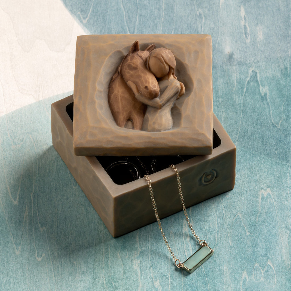 Willow Tree Quiet Strength Keepsake Box, 3”sq x 2.5”h hand-painted resin box with removable lid off to one side. Lid has bas-relief carving of girl in cream dress, arms around neck of reddish-color horse