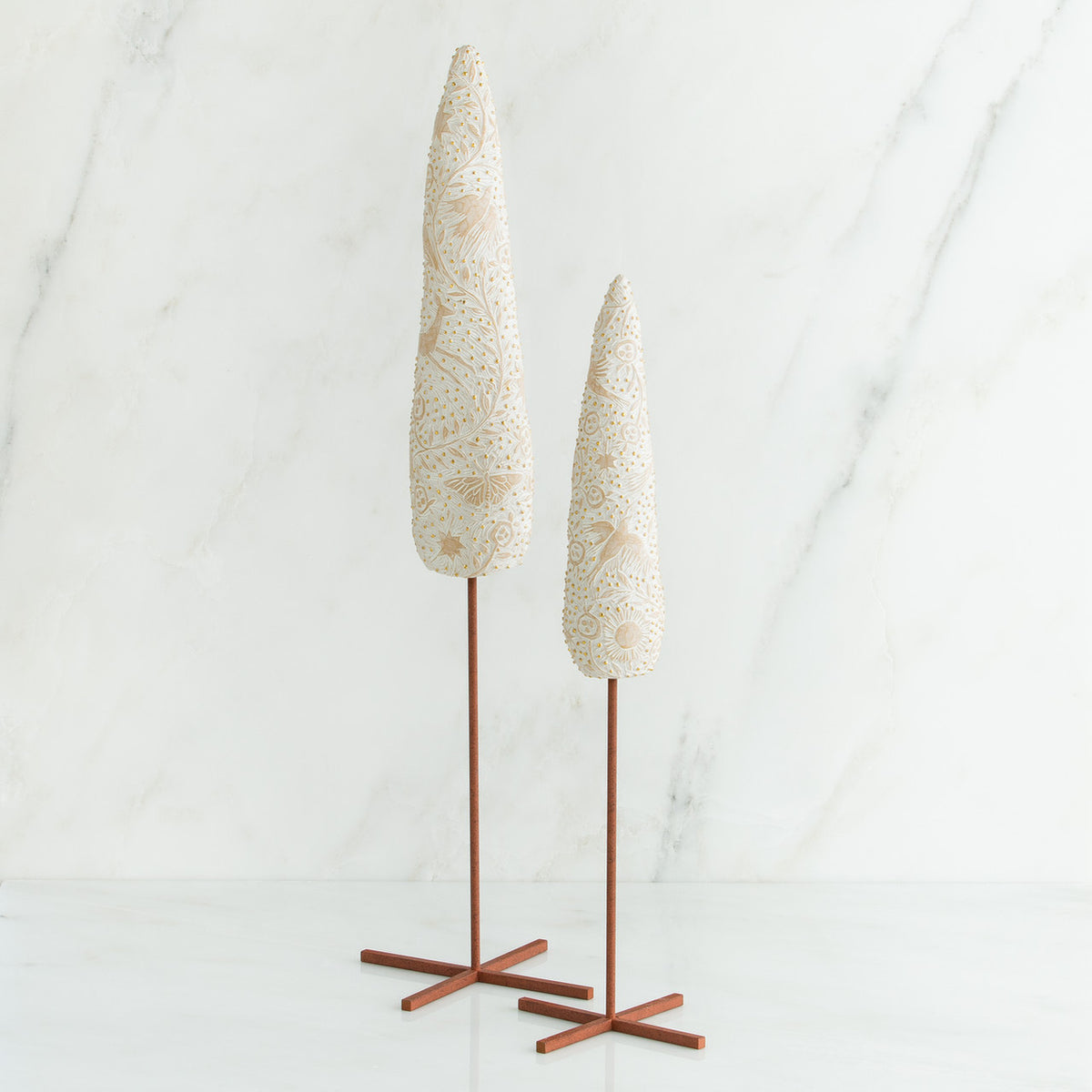 Set of two white tree figurines with wooden stands - all white background