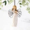 Female angel figure in cream dress with wire wings, holding brown dog in arms, ornament loop attached to head
