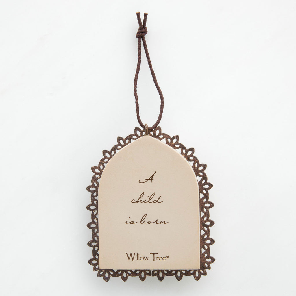 Round cream pendant with wooden outline - center says 'a child is born'