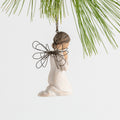 Side view figure of female angel in cream dress and wire wings, kneeling in prayer position, ornament loop on head
