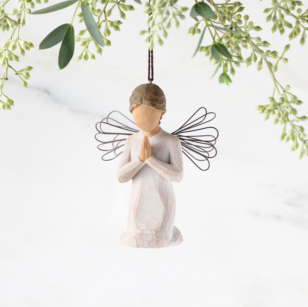 Figure of female angel in cream dress and wire wings, kneeling in prayer position, ornament loop on head