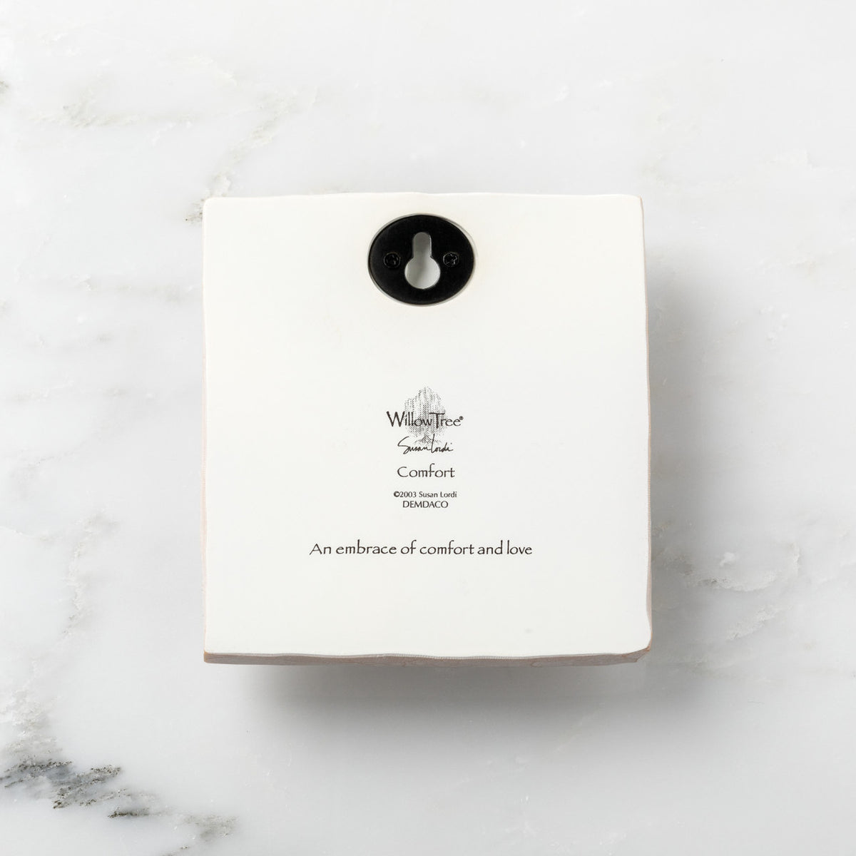 Back of white plaque reading piece title and sentiment, with Willow Tree logo