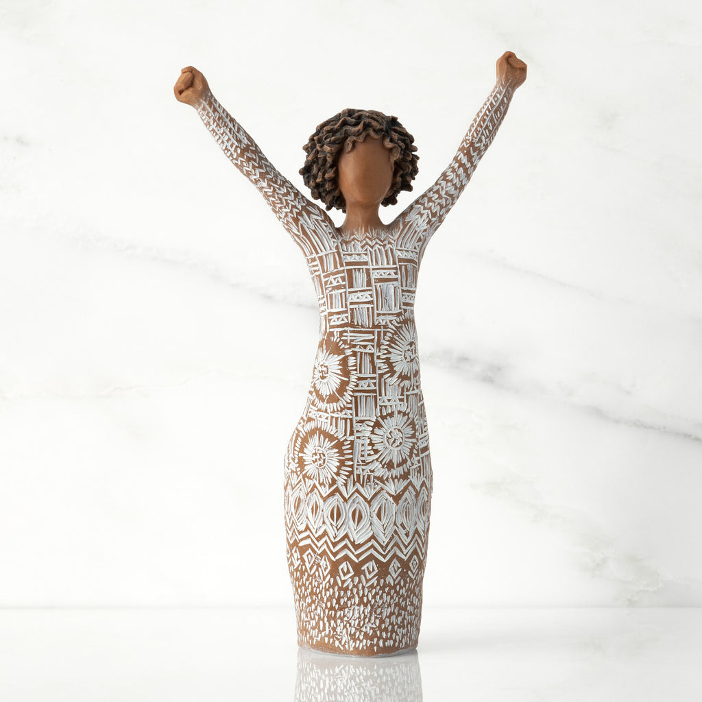 Front view of figure with natural hairstyle, arms raised overhead, dress etched with African textile patterns