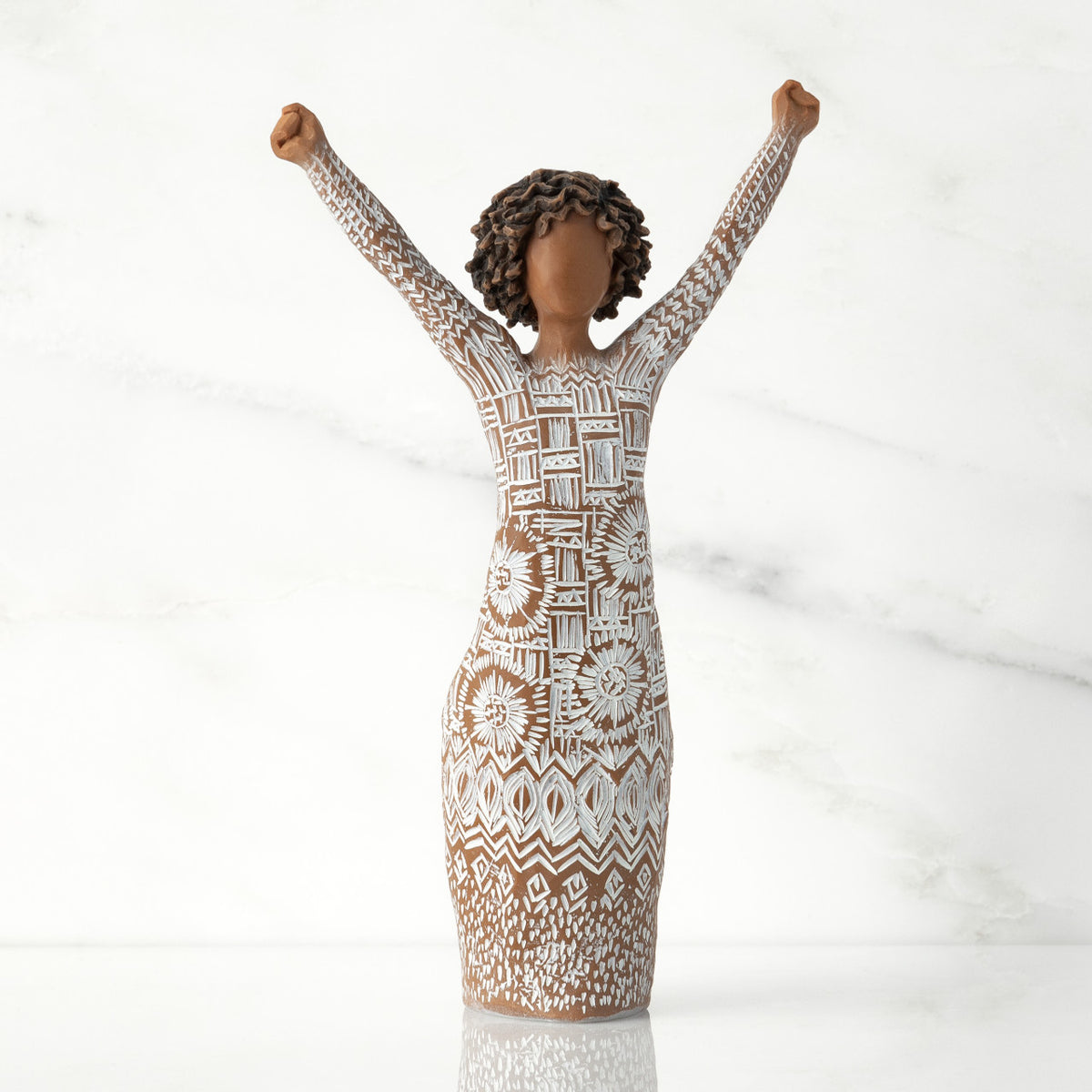 Front view of figure with natural hairstyle, arms raised overhead, dress etched with African textile patterns